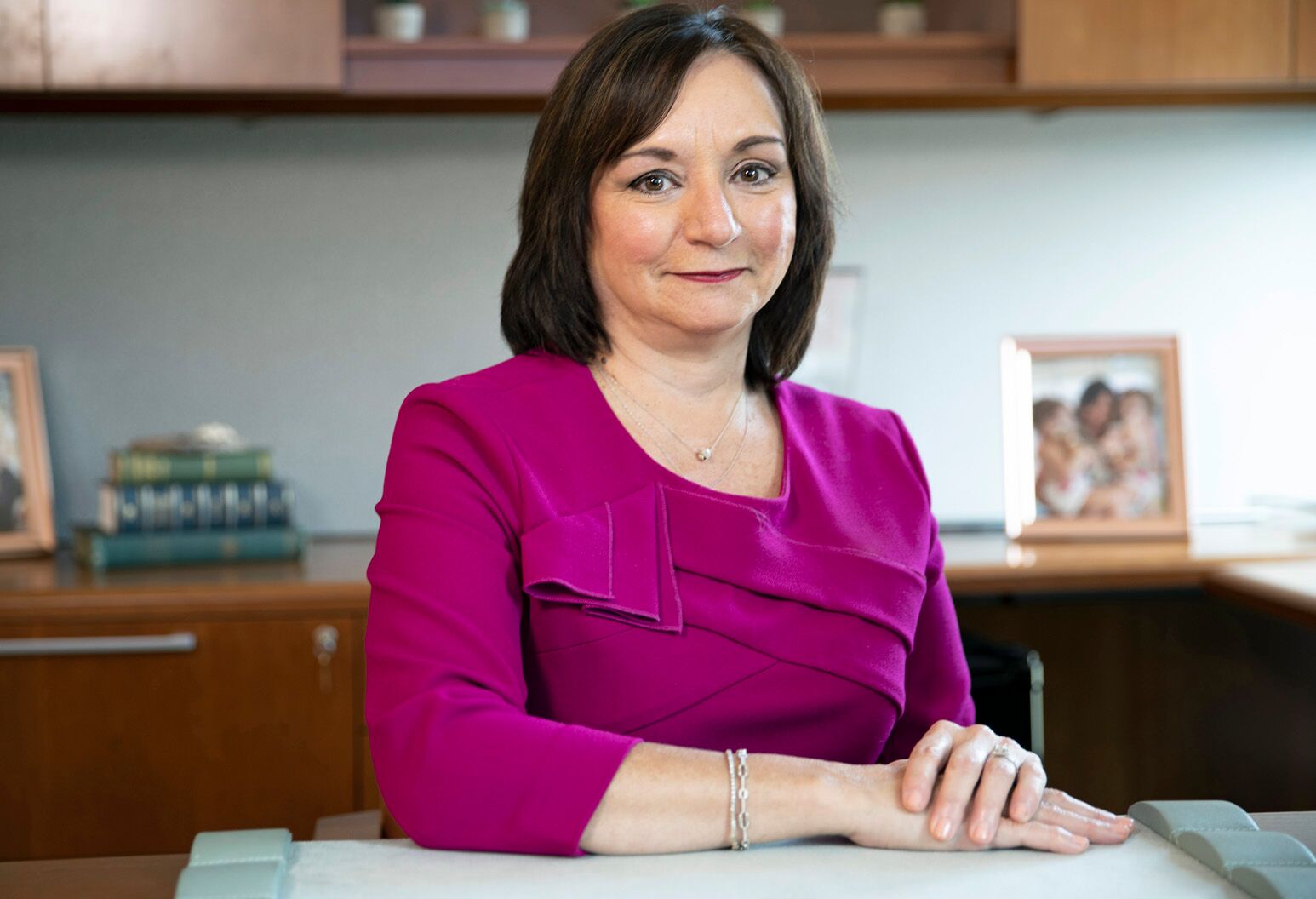 An image of Dr. Debbie Salas-Lopez, MD, MPH, at her desk.