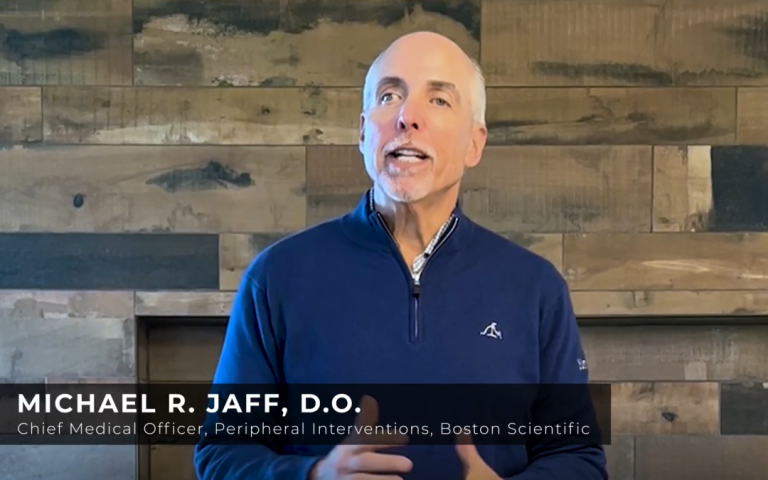 Michael R. Jaff, DO, speaks on camera indoors, wearing a blue pullover, identified as Chief Medical Officer for Peripheral Interventions at Boston Scientific.