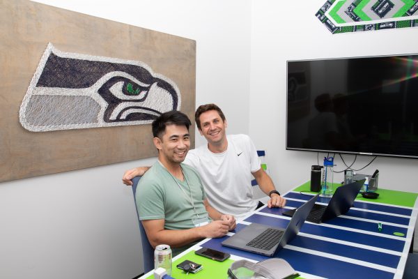 Dr. Ryan Lee and Paul Carroll in a Seahawks-themed office