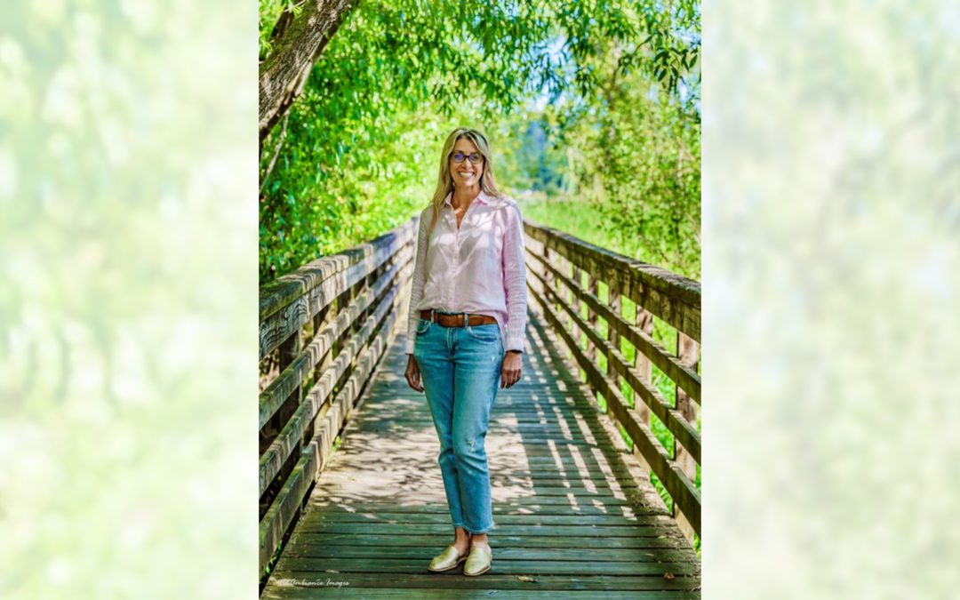 An image of Deb Nielsen, standing on a bridge.