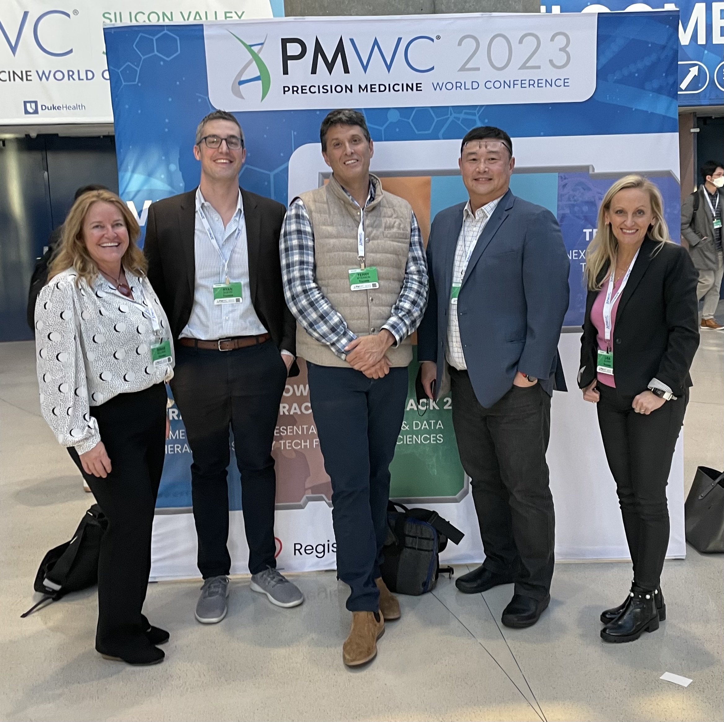 Susan Williams, Dr. Ryan Ahern, Terry Myerson, Dr. Frederick Lee, and Lisa Gurry, in front of the PMWC sign